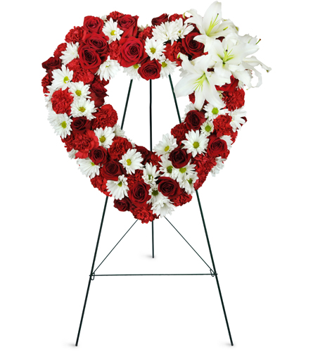 Heart shaped memorial wreath with pink roses and white stocks