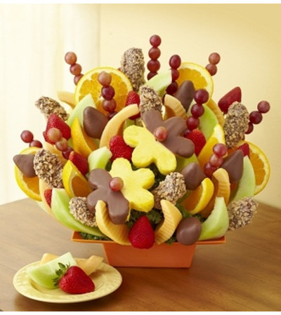 BE THE FIRST TO KNOW! Make any celebration even more delicious with one of our signature fresh fruit arrangements! The Delicious Celebration® is a fun, brightly-colored treat filled with an assortment of all our favorite fresh fruits: pineapple stars, pineapple daisies, strawberries, and more.
